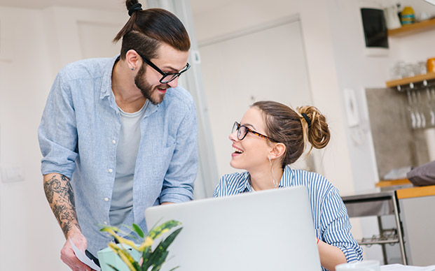 Young couple at home on computer